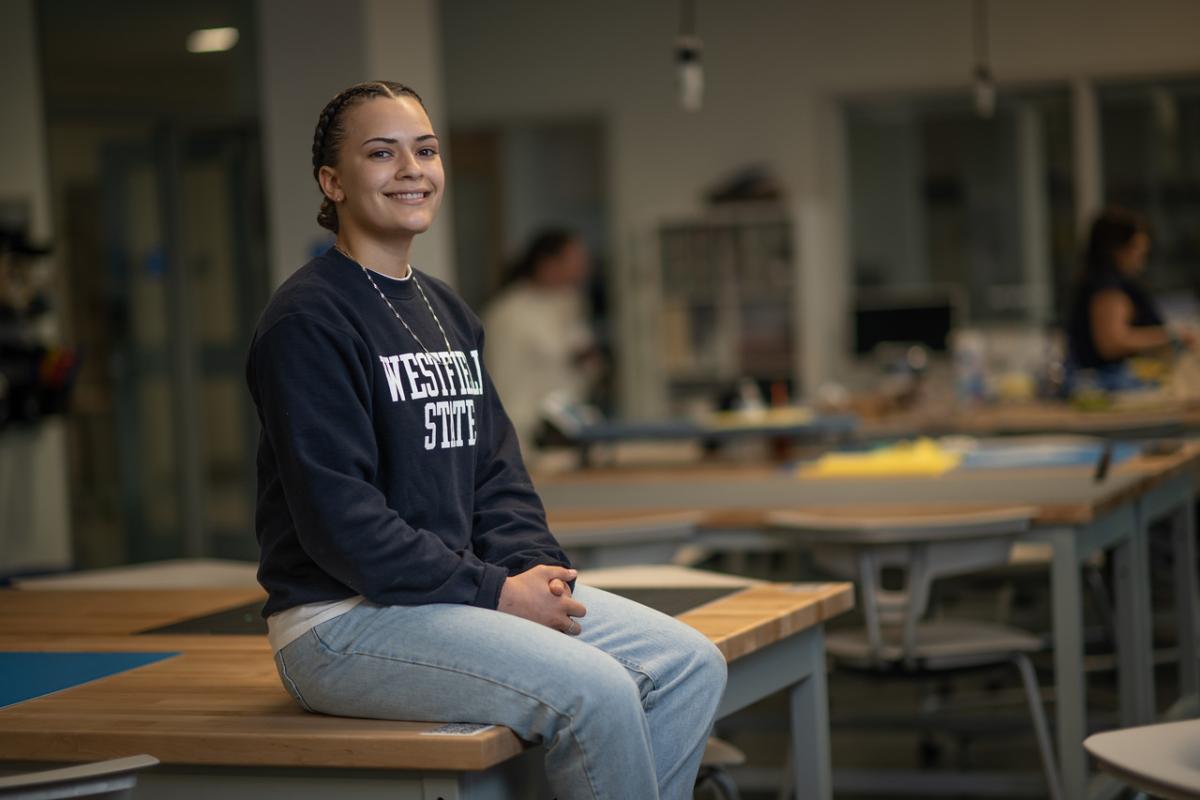 Communication student smiling in the Research, Innovation, Design and Entrepreneurial Center.