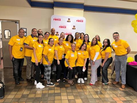 The Western MA Caring Force, all dressed in yellow shirts, posing in Scanlon Hall for the The Western MA Caring Force Rally, held on September 17.