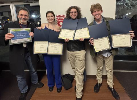 Faculty member and students holding awards at the Region 1 Kennedy Center American College Theatre Festival (KCACTF).