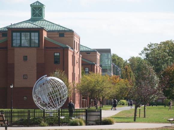 View of the campus green, looking toward Courtney Hall and the globe sculpture