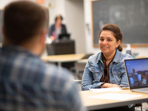 female student talking to another student in class