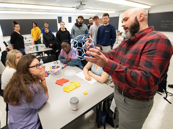 Alex Moore teaching students in a classroom