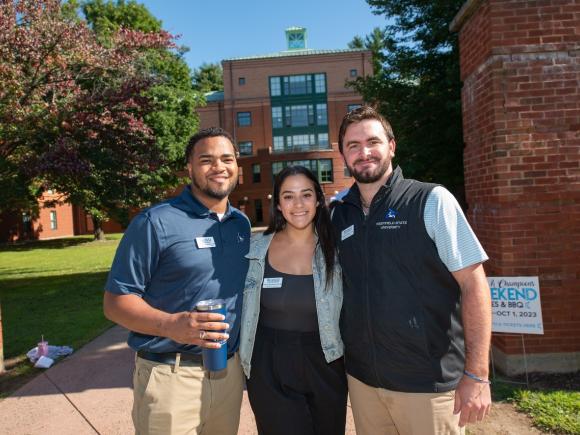 Admissions staff smiling at campus move-in event.