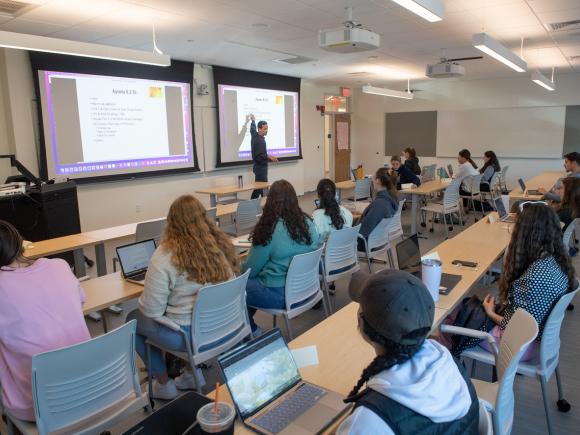 Faculty member giving a presentation in an education classroom.