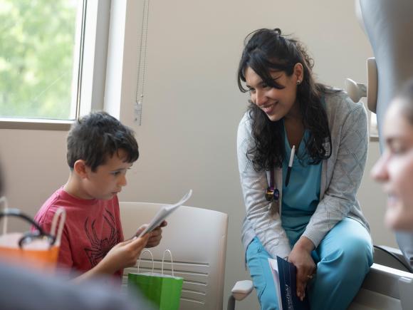 Student smiling while engaged in a hands-on activity in the simulation lab.
