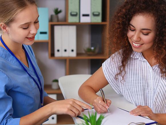 two woman reviewing paperwork