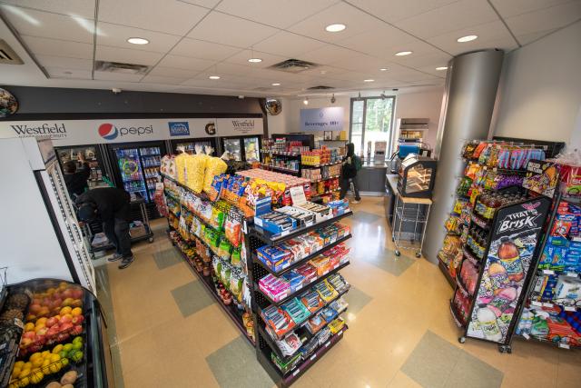 Marketplace store with fruit and shelves with candy and snacks.