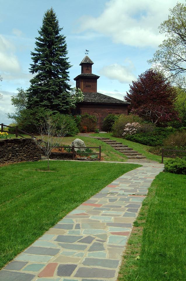 Stanley Park stone path with brown building and stairs.