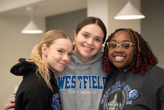 Three students smiling wearing Westfield State sweatshirts.