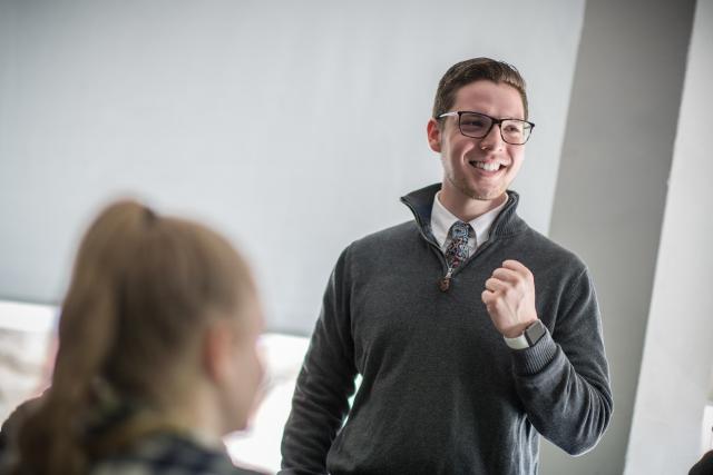 Student smiling at an internship as a Spanish Teaching Assistant.