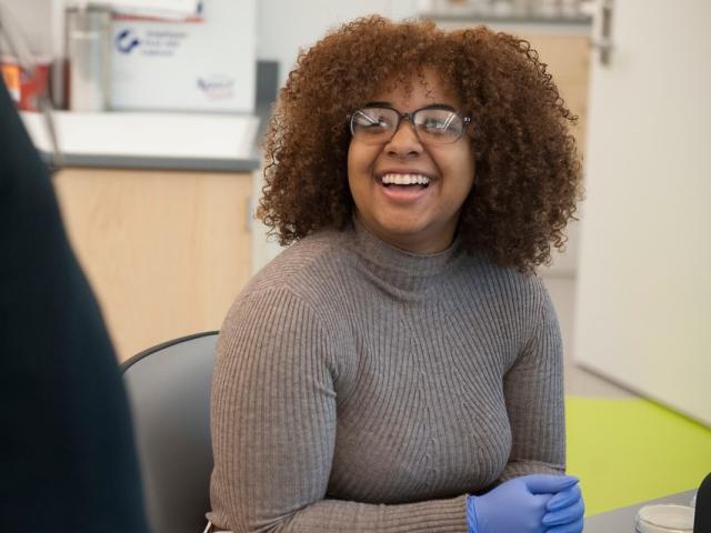 Biology student smiling at internship.