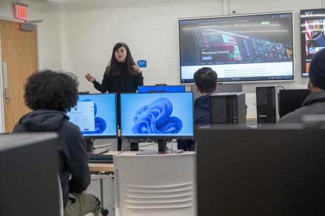 Faculty member teaching students in the Finance and Data Analytics Lab.