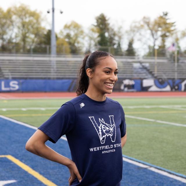 Student athlete smiling on the athletics field.